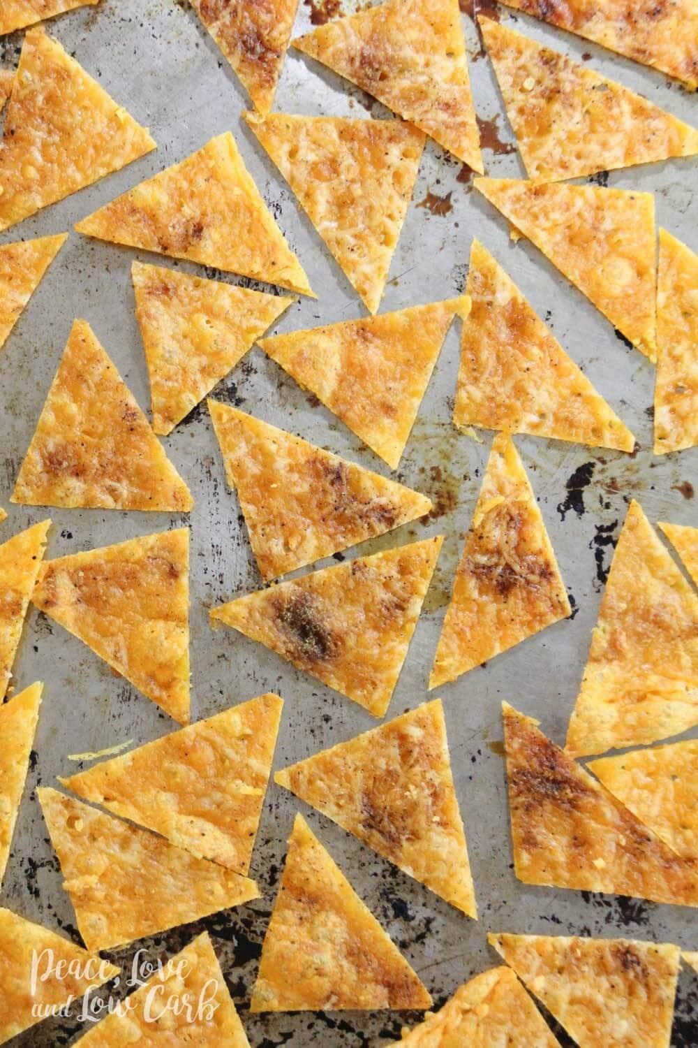 a rimmed baking sheet, topped with chips made out of cheese. 