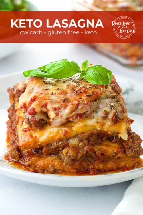 A white plate with a serving of low carb and gluten free lasagna, garnished with basil.