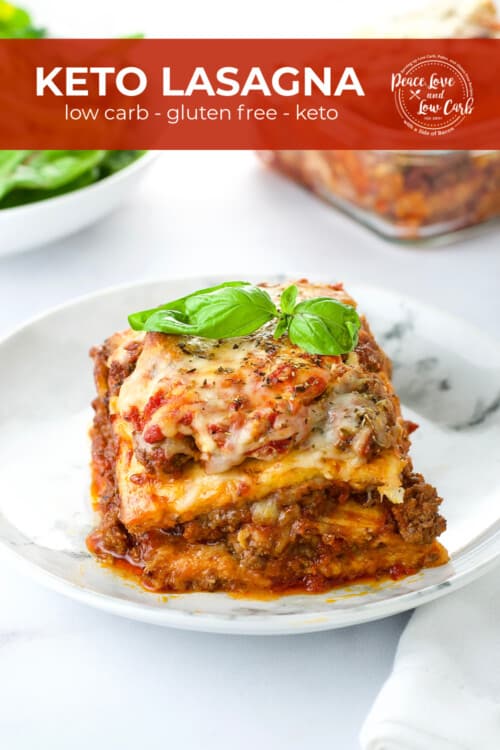 A white plate with a serving of low carb and gluten free lasagna, garnished with basil.