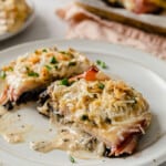 a rimmed baking sheet with parchment paper, topped with portobello mushrooms, cooked with Cordon Bleu toppings