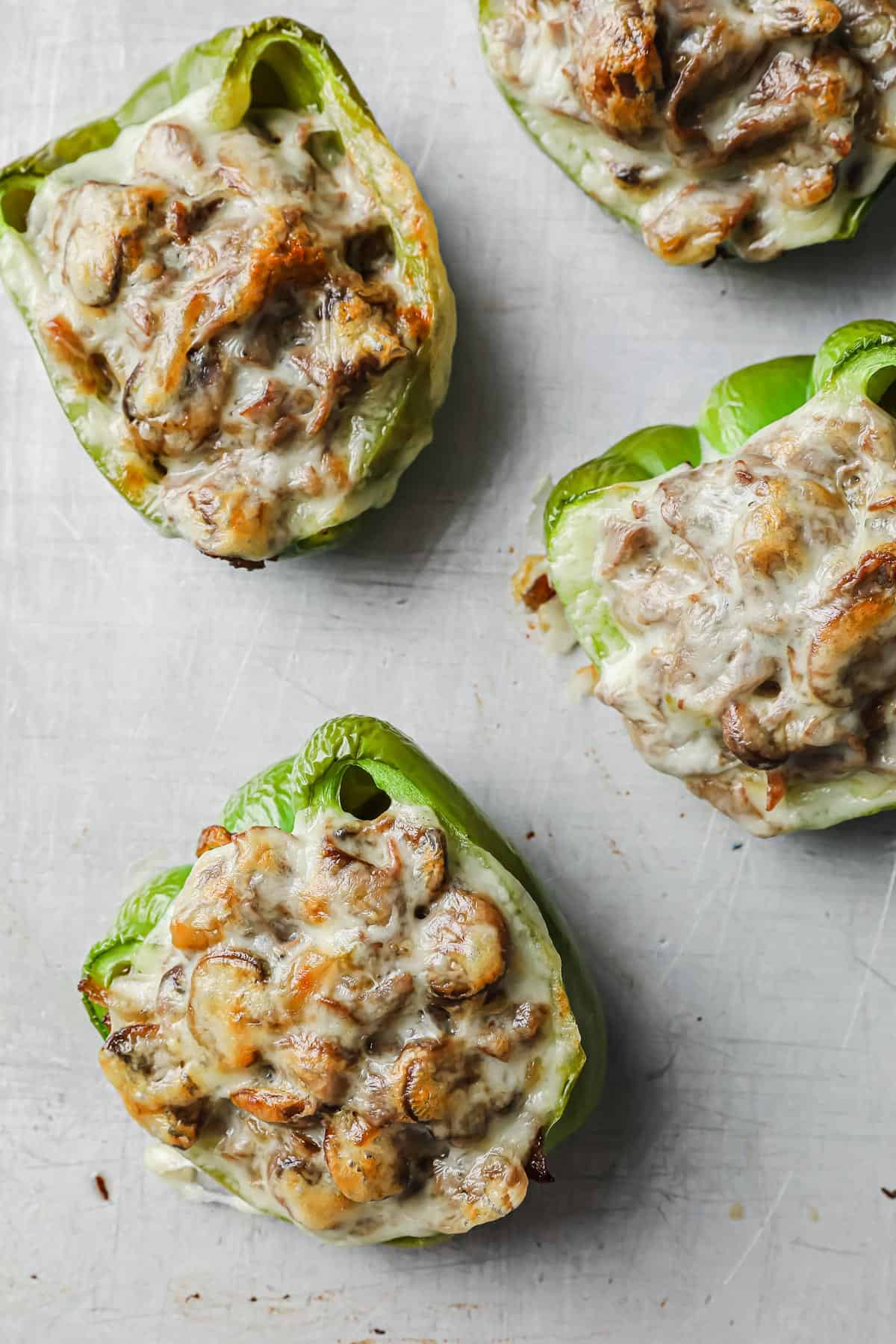 green bell peppers stuffed with roast beef, provolone cheese, mushrooms, onions, and garlic