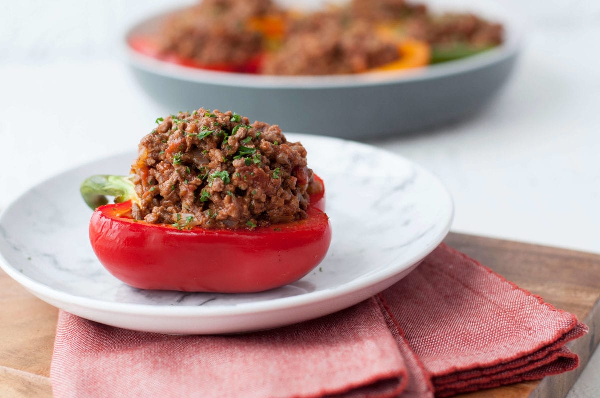 half of a red bell pepper, stuffed with a homemade sloppy Joe mixture, and garnished with parsley.