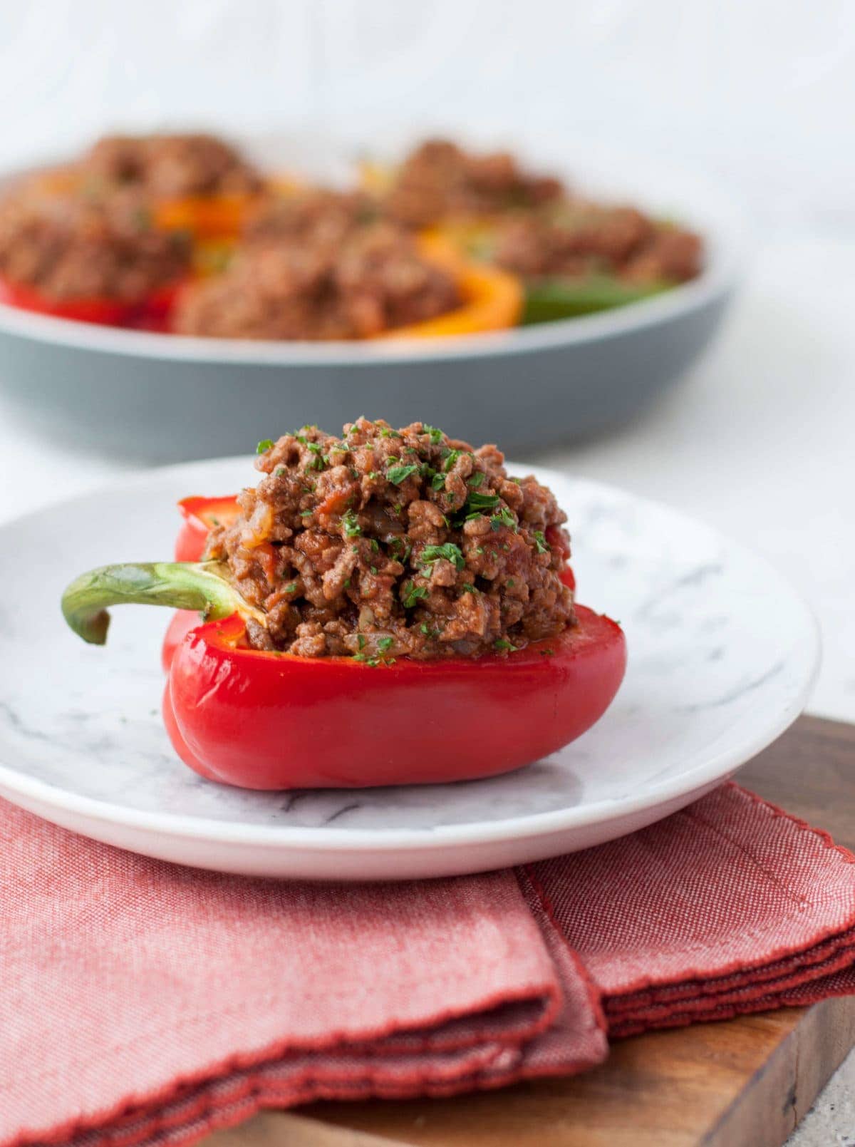 half of a red bell pepper, stuffed with a homemade sloppy Joe mixture, and garnished with parsley.