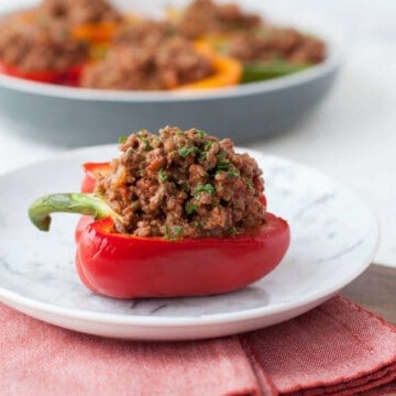 half of a red bell pepper, stuffed with a homemade sloppy Joe mixture, and garnished with parsley.