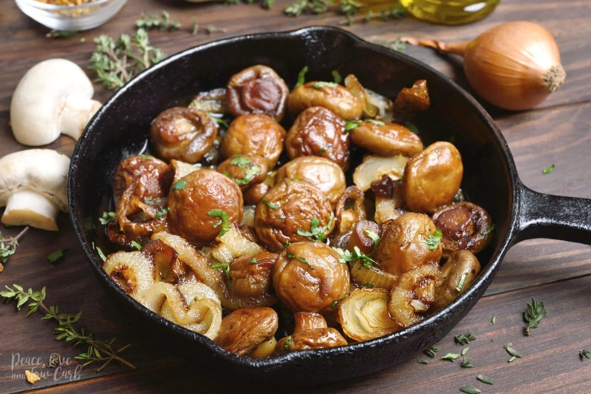 A cast iron skillet full of sautéed mushrooms and onions, garnished with parsley