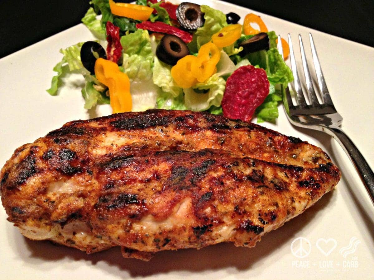 chicken breast cooked with blackened seasoning and dijon mustard, served with a side salad and a fork