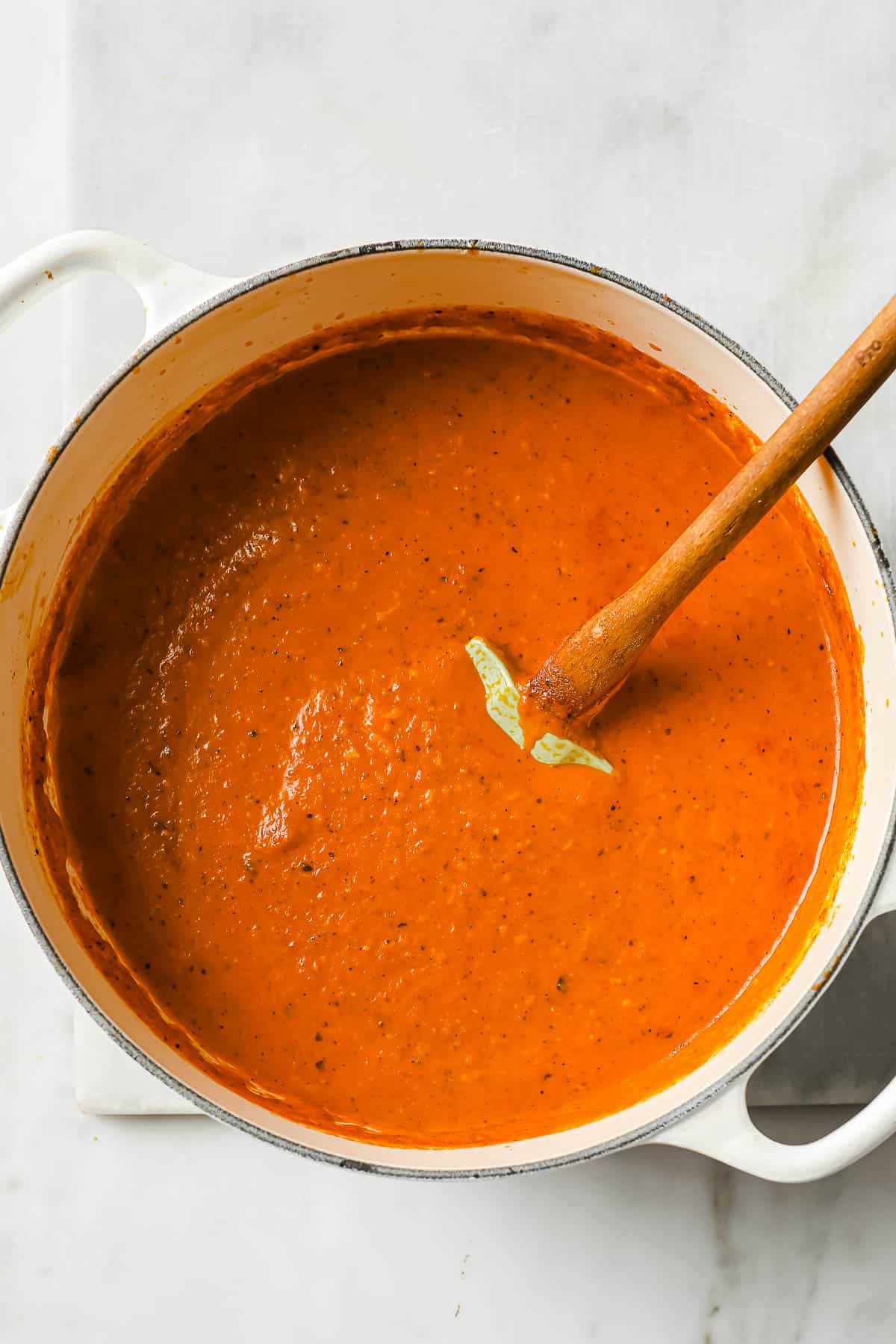 a dutch oven full of roasted red pepper bisque
