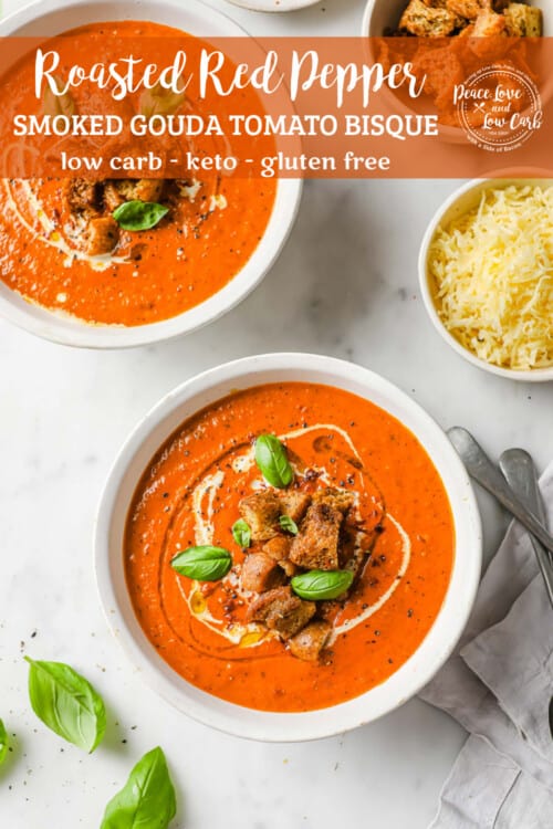 2 bowls of low carb tomato soup, garnished with keto croutons, fresh basil and a swirl of cream