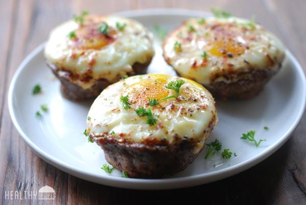 Egg and Sausage Muffins on a white plate, garnished with parsley