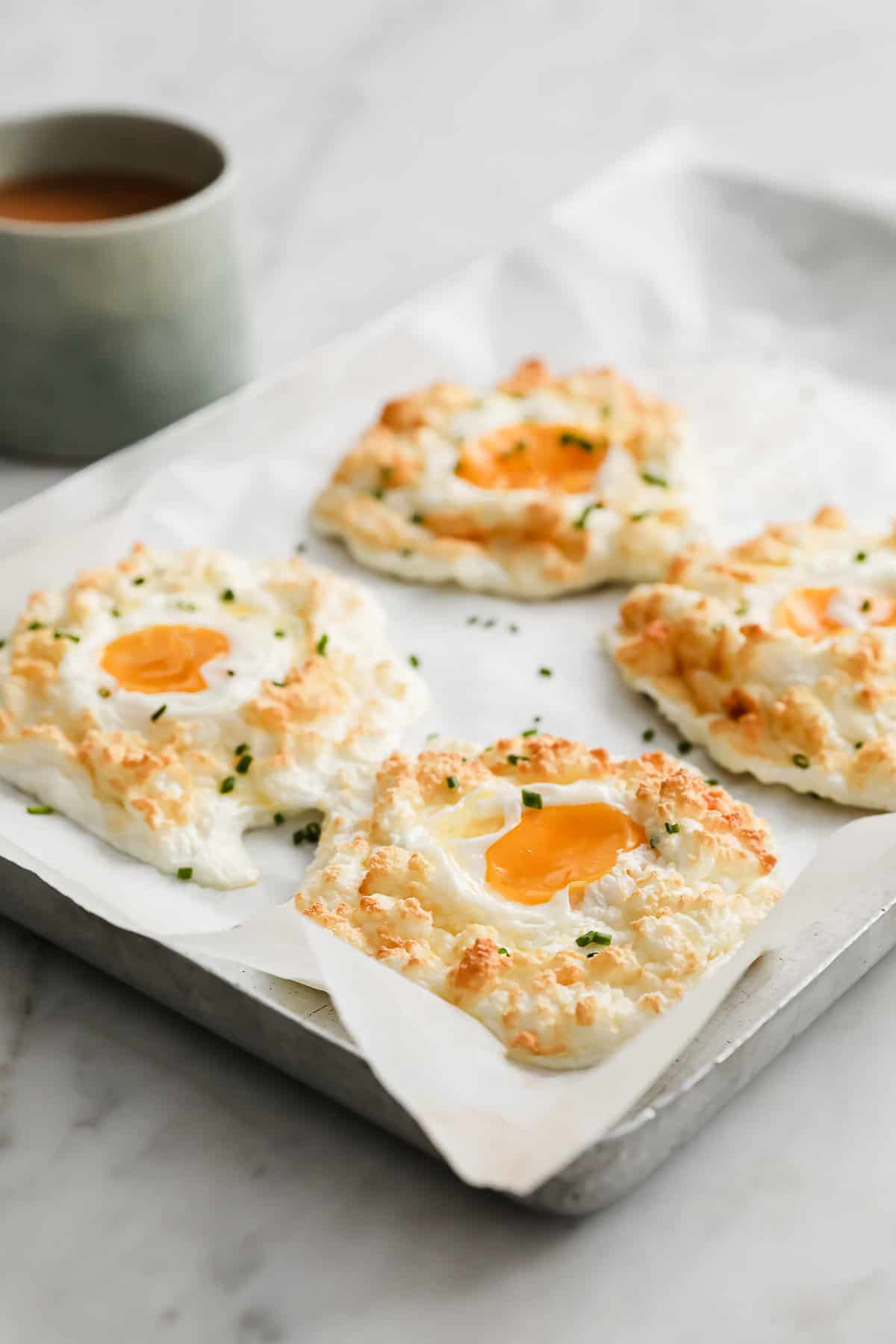 sour cream and chive egg clouds on a baking sheet lined with parchment paper