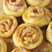 Hot Ham and Cheese Roll-Ups with Dijon Butter Glaze