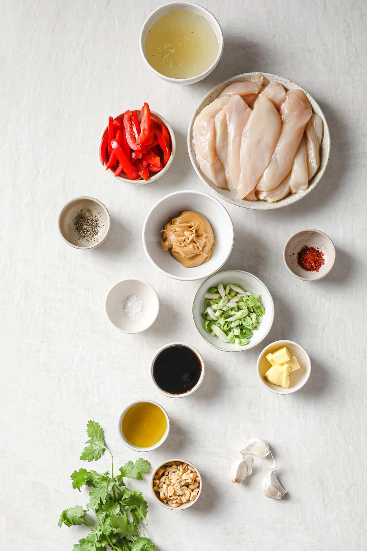 ingredients to make peanut butter chicken - chicken, peanut butter, red peppers, soy sauce, green onions olive oil