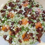 A skillet breakfast made with heavy cream, sour cream, bacon, garlic, and fresh herbs.