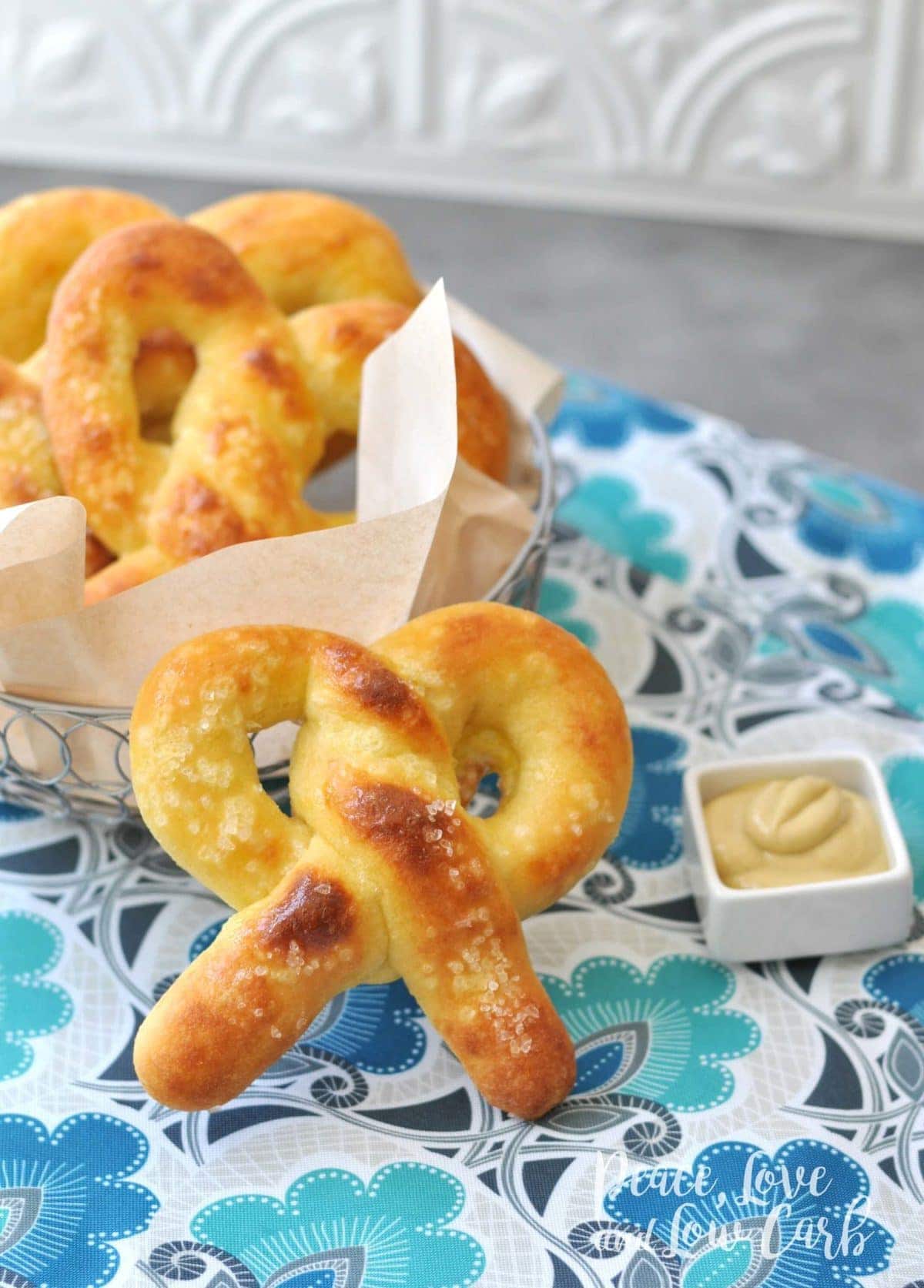 soft pretzels served in a wire basket and served with mustard fro sipping