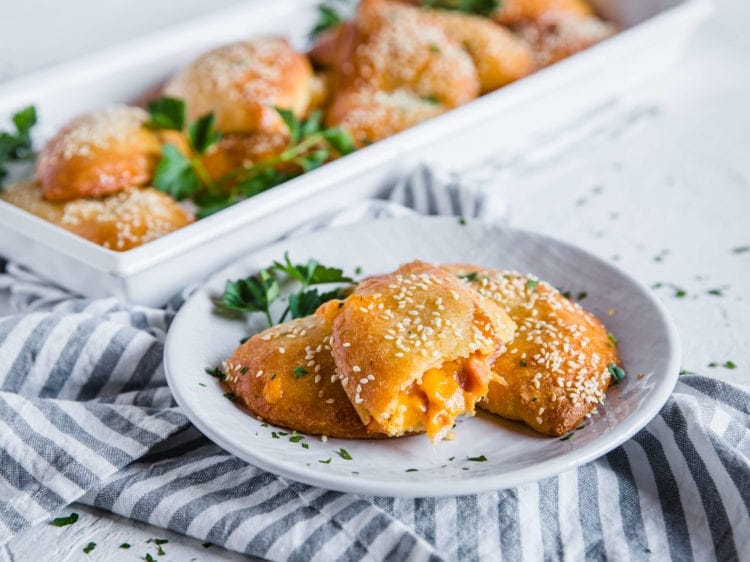 Melty, cheesy, Ham and Cheese Keto Hot Pockets, plated with a side view of the filling