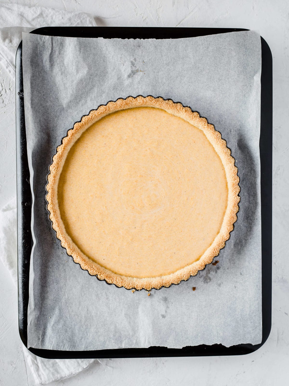 keto pumpkin pie filling ready to be baked in gluten free pie crust.