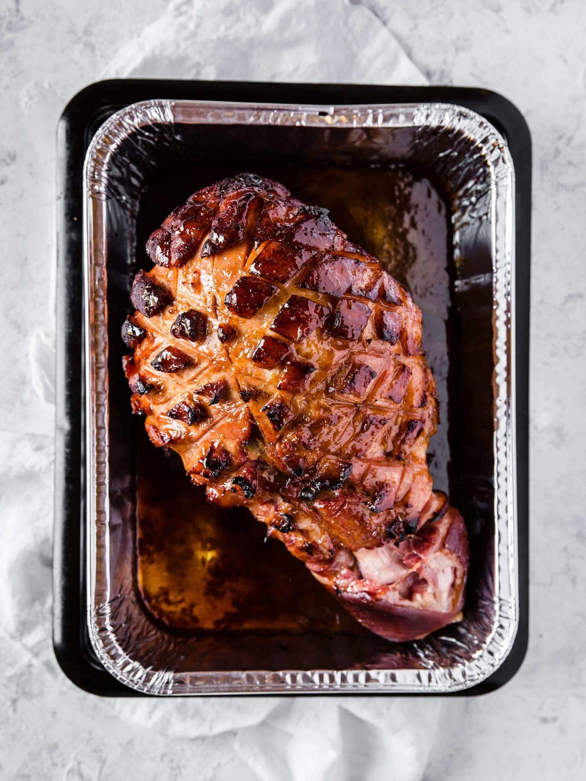 keto glazed ham fresh out of the oven, served in an aluminum baking tin