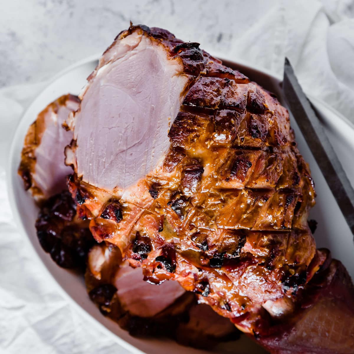 a glazed ham fresh out of the oven, sliced in a serving dish