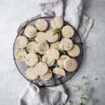 a big plate of keto crackers surrounded by fresh herbs