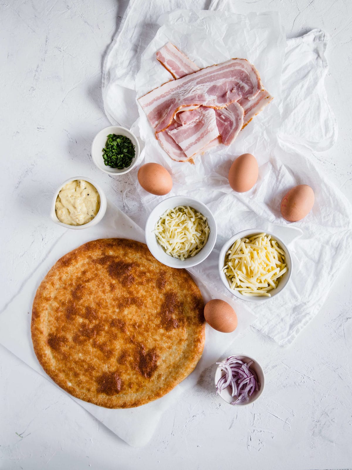 Overhead shot of ingredients for a gluten free breakfast pizza