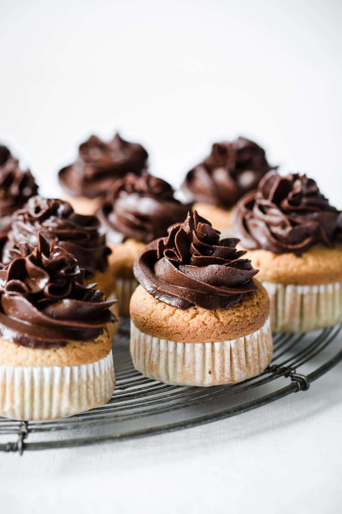 Frosted cupcakes on a cooling rack