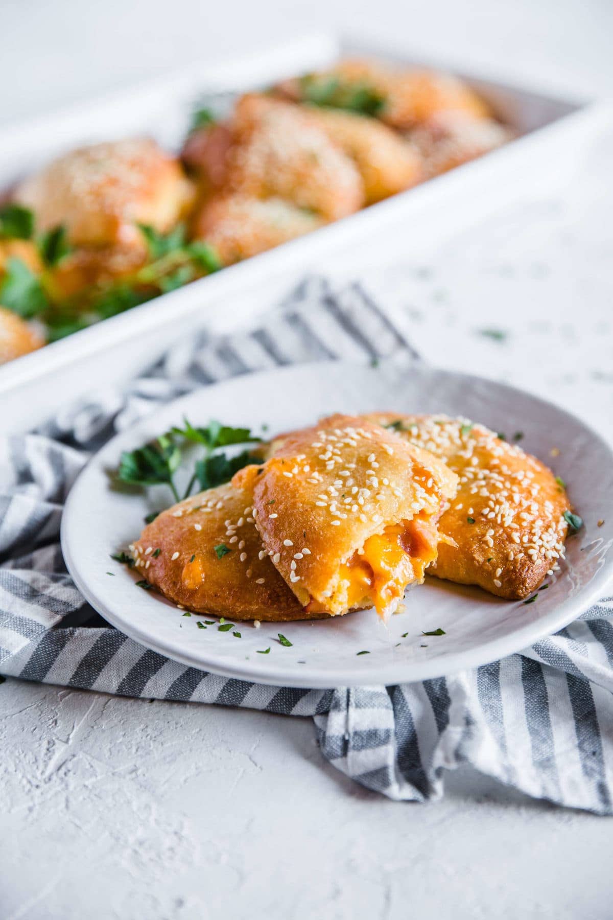 Melty, cheesy, Ham and Cheese Keto Hot Pockets, plated with a side view of the filling