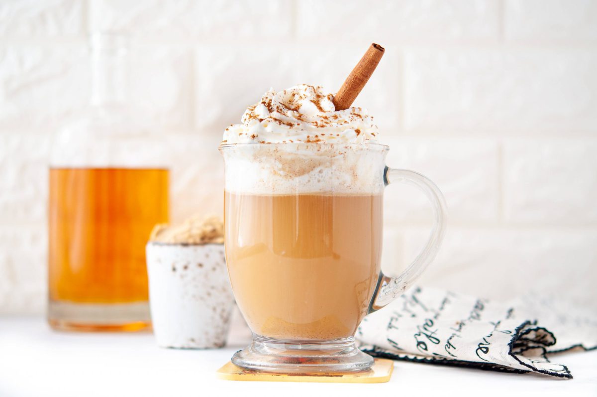 Clear glass coffee mug, full of low carb cocktail - pumpkin spice hot buttered rum