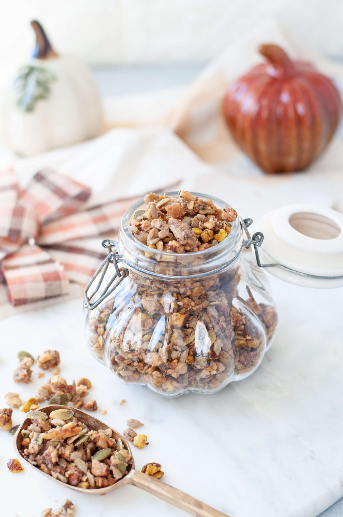 Gluten Free granola in a decorative glass jar, shaped like a pumpikin