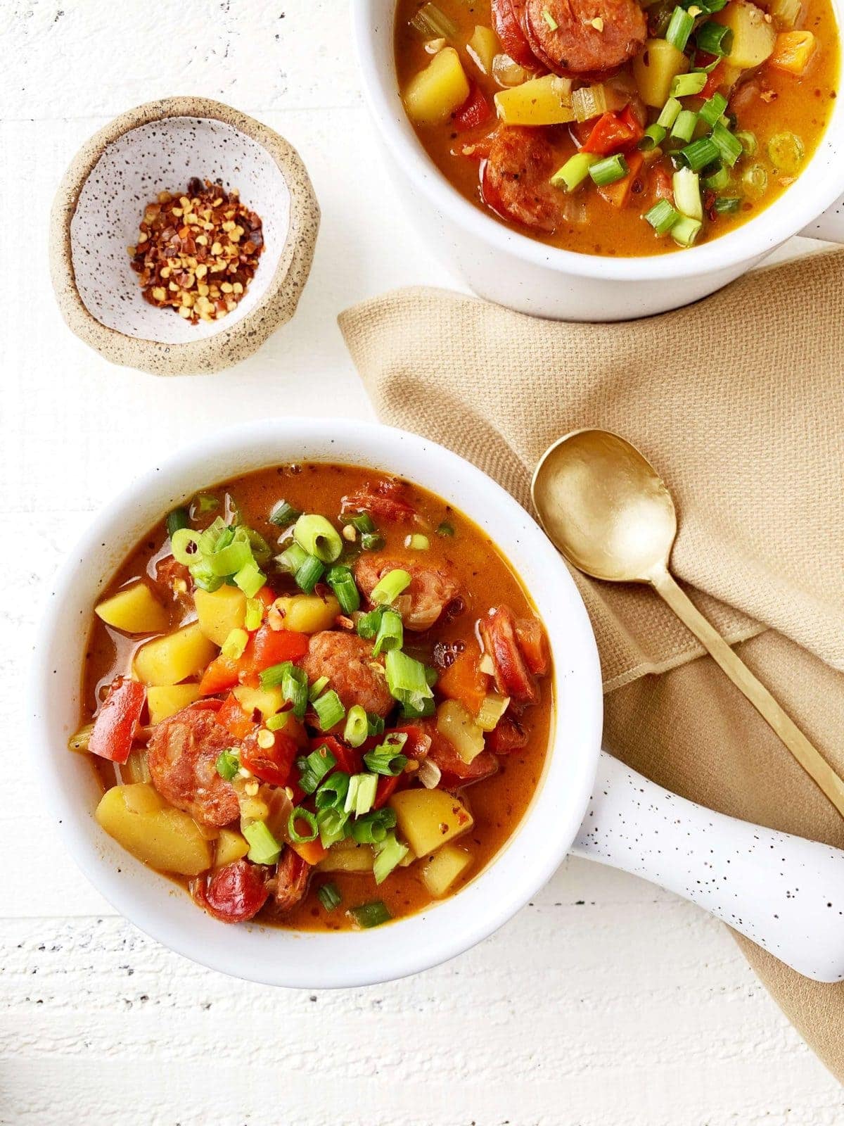 overhead shot of a really colorful bowl of whole30 cajun soup - peppers, celery, sausage, onions, potatoes