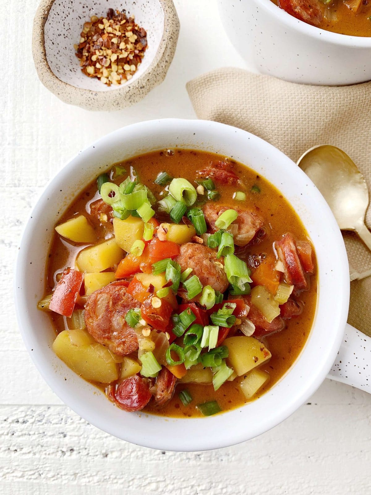 overhead shot of a really colorful bowl of whole30 cajun soup - peppers, celery, sausage, onions, potatoes