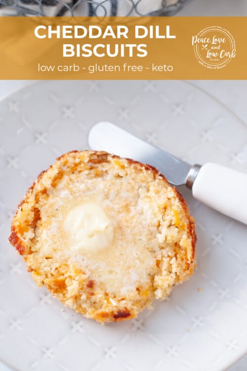 A fresh baked low carb biscuit, cut in half and topped with butter.