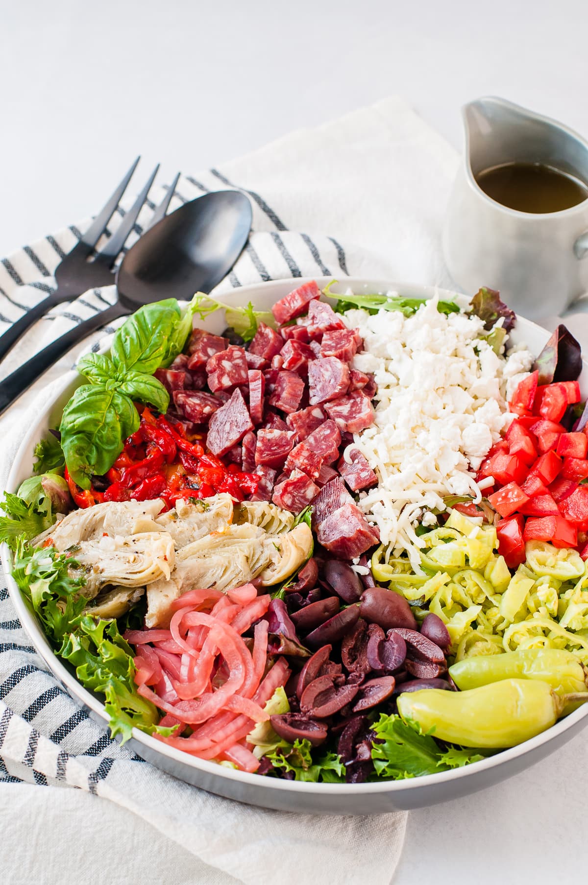 Overhead shot of a brightly colored antipasto salad - topped with meats, cheese, and vegetables