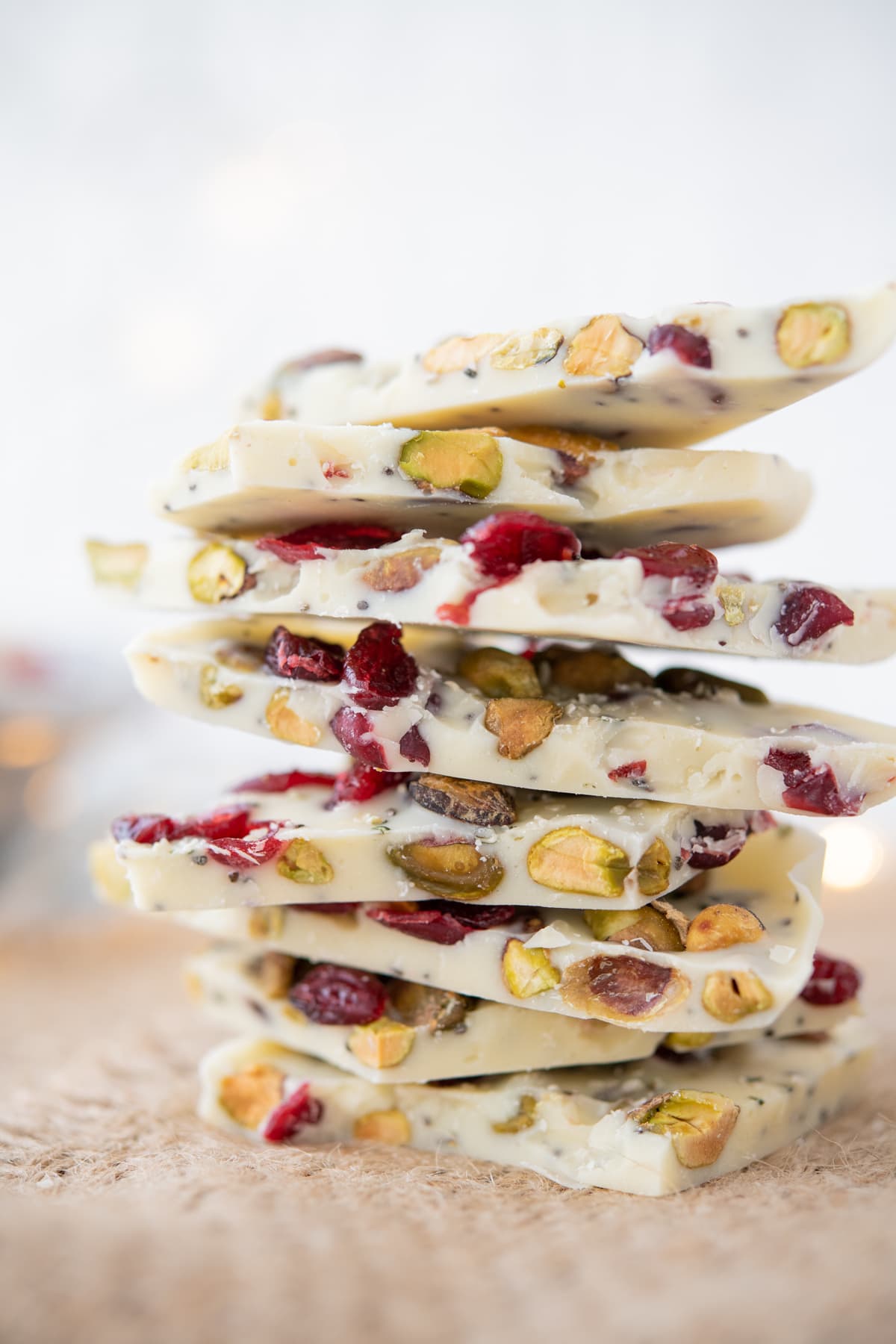 close up of white chocolate bark with nuts, seeds, and cranberries piled high