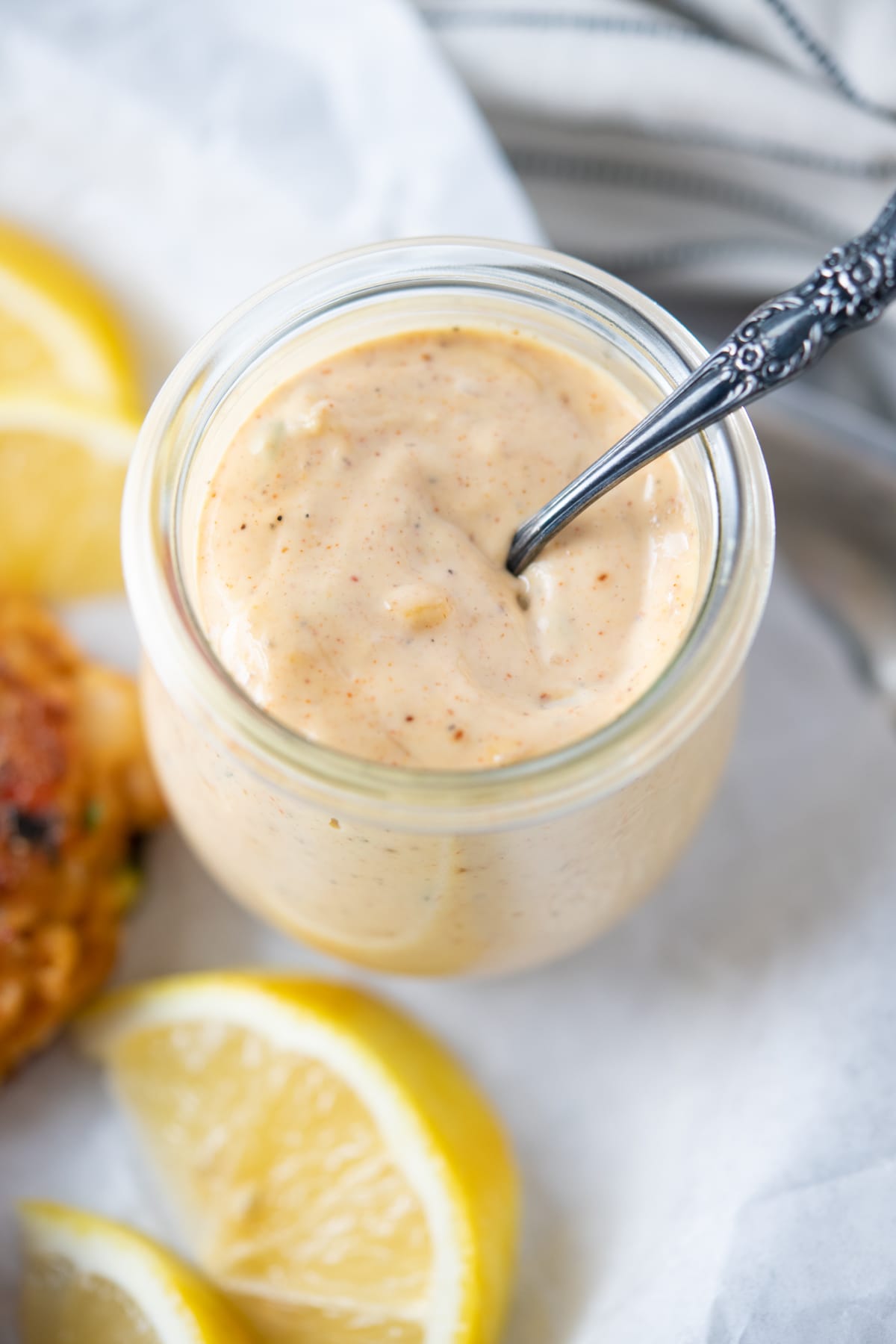 Remoulade sauce served with lemon and shrimp cakes