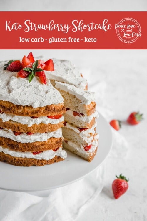 keto Strawberry shortcake, with layers of fresh cream and strawberries on a cake stand