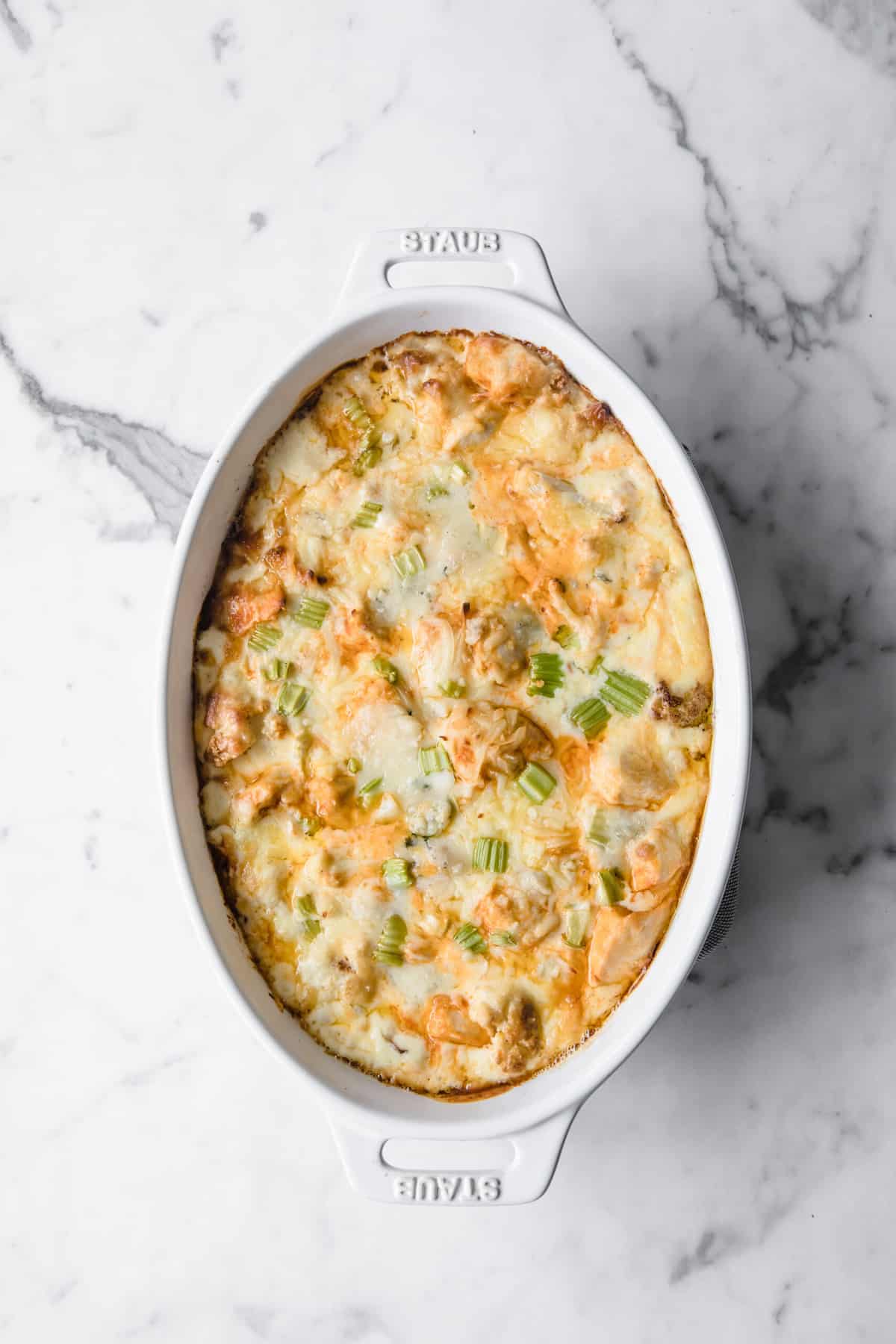 white casserole dish with low carb buffalo chicken Mac and cheese