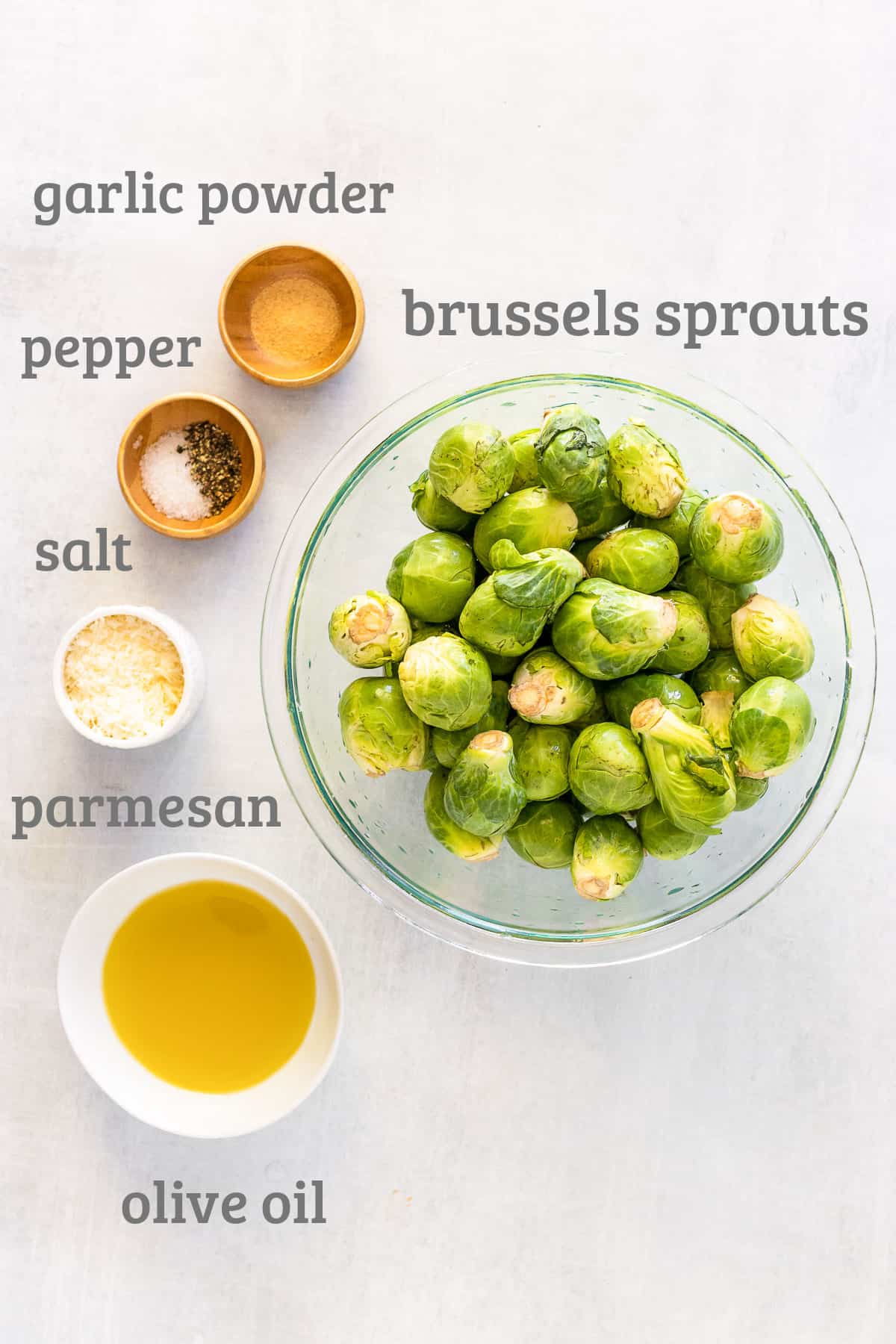 Ingredients for brussels sprouts chips - brussels sprouts, parmesan, olive oil, salt, pepper, and garlic powder