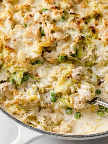 a skillet full of low carb tuna casserole, rich and creamy sauce, baked golden brown with cheese.
