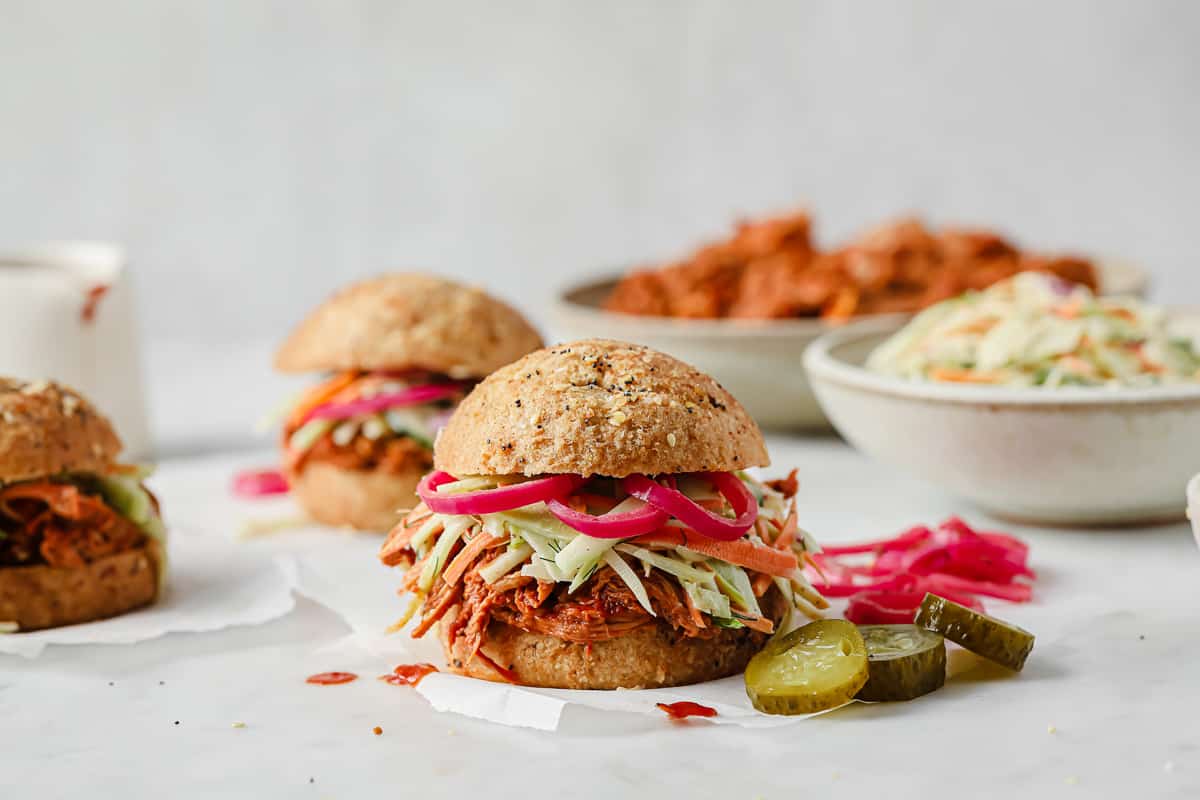 keto barbecue pulled pork sandwiches with cucumber dill slaw, pickled red onions
