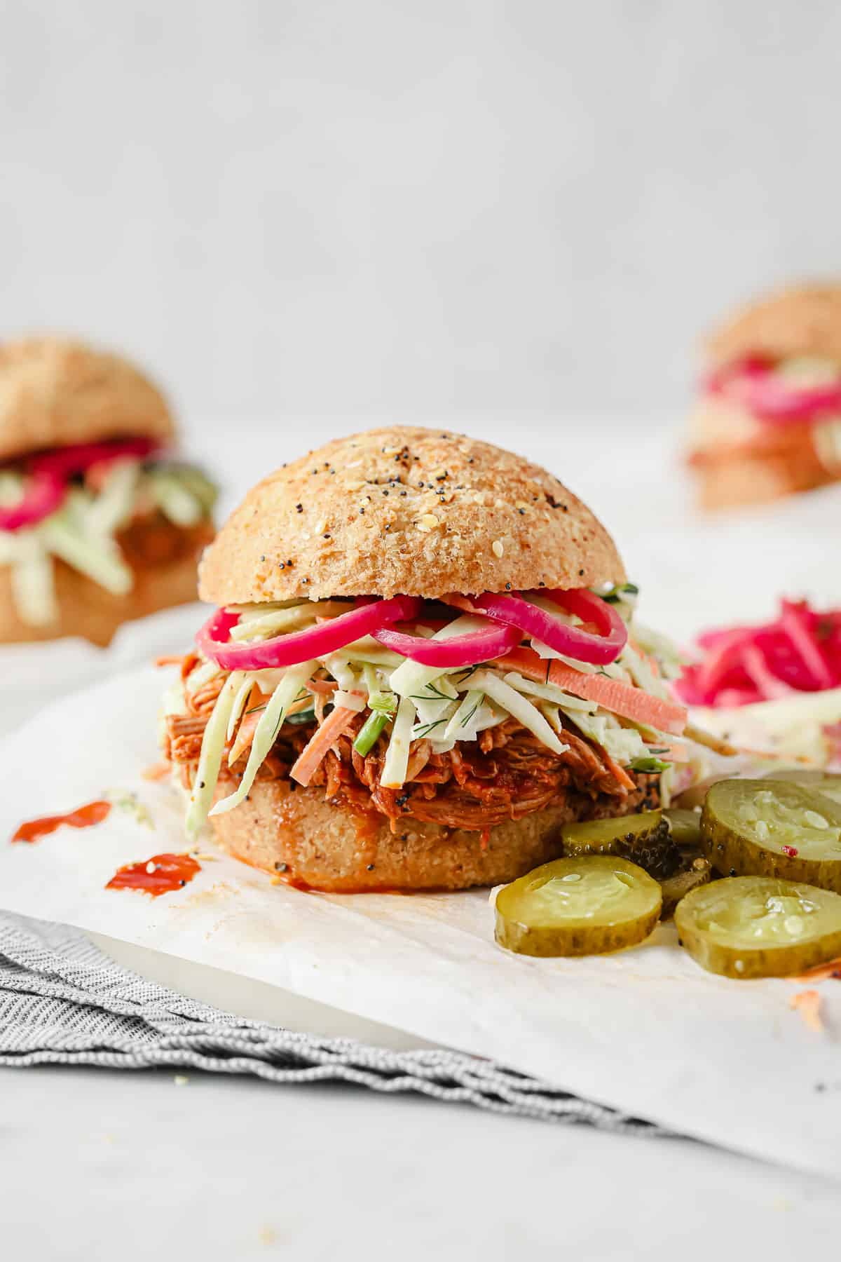 keto barbecue pulled pork sandwiches with cucumber dill slaw, pickled red onions