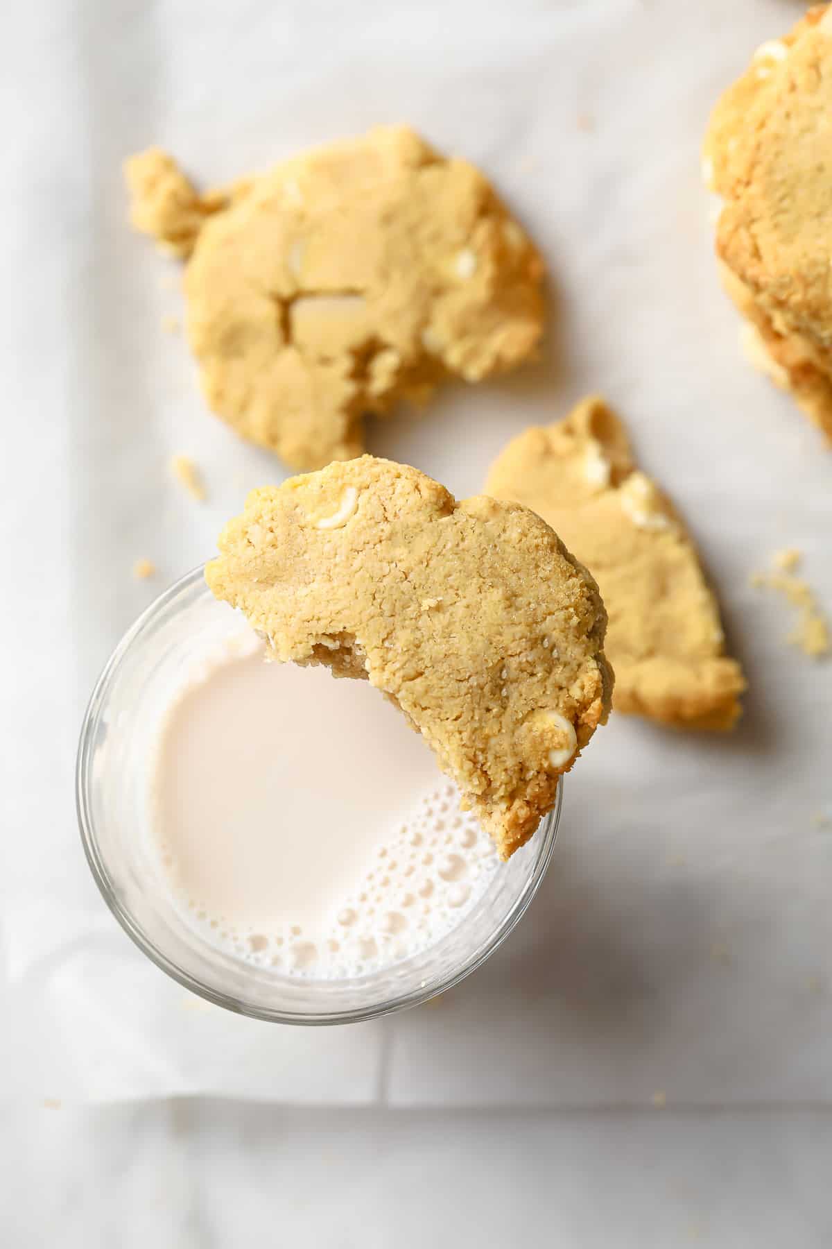 keto white chocolate macadamia nut cookies fresh out of the oven with a cold glass of milk