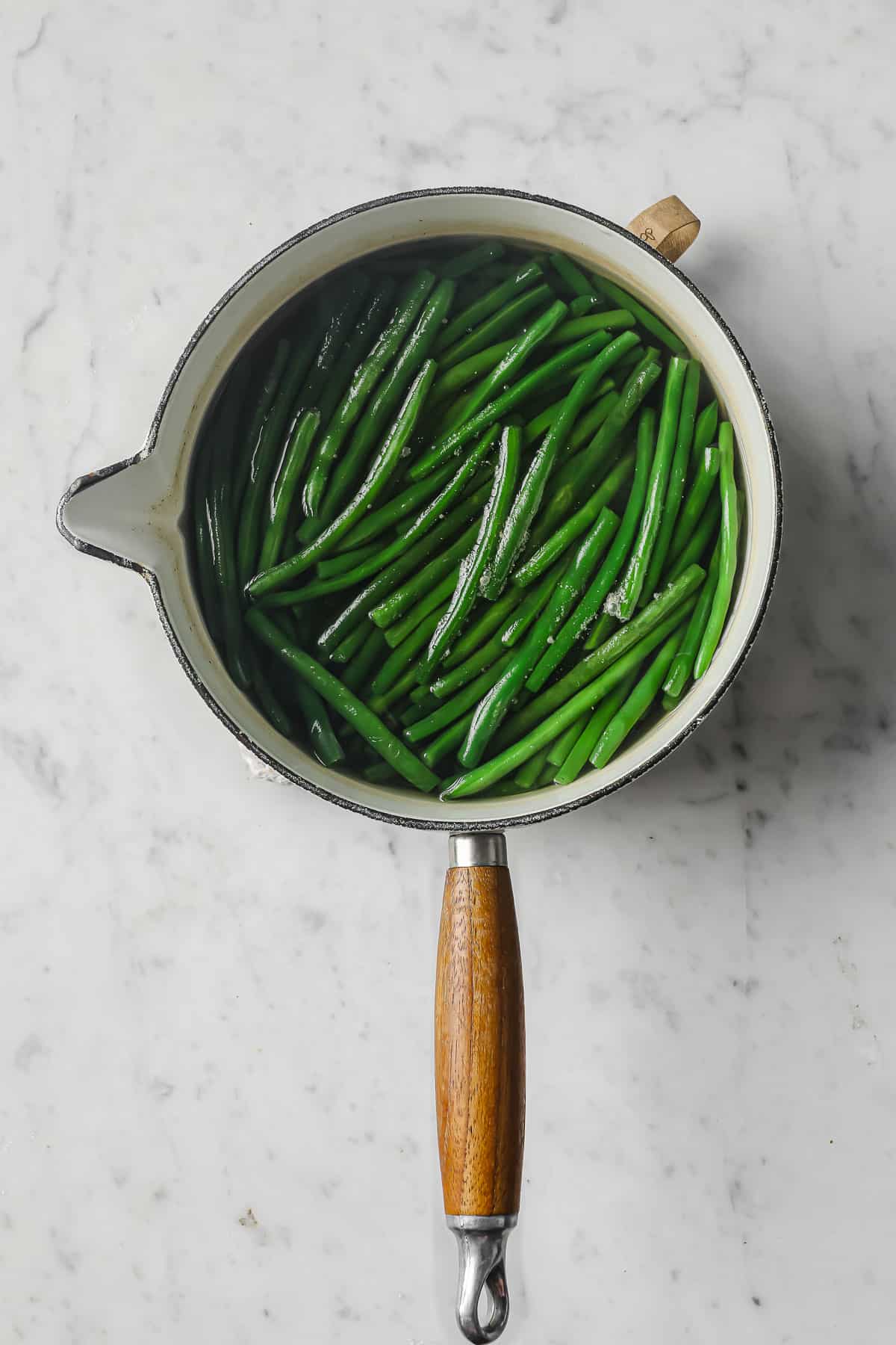 fresh green beans in a boiling pot of water