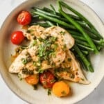 sautéed chicken cutlets with lemon butter caper sauce, served with blistered tomatoes and green beans