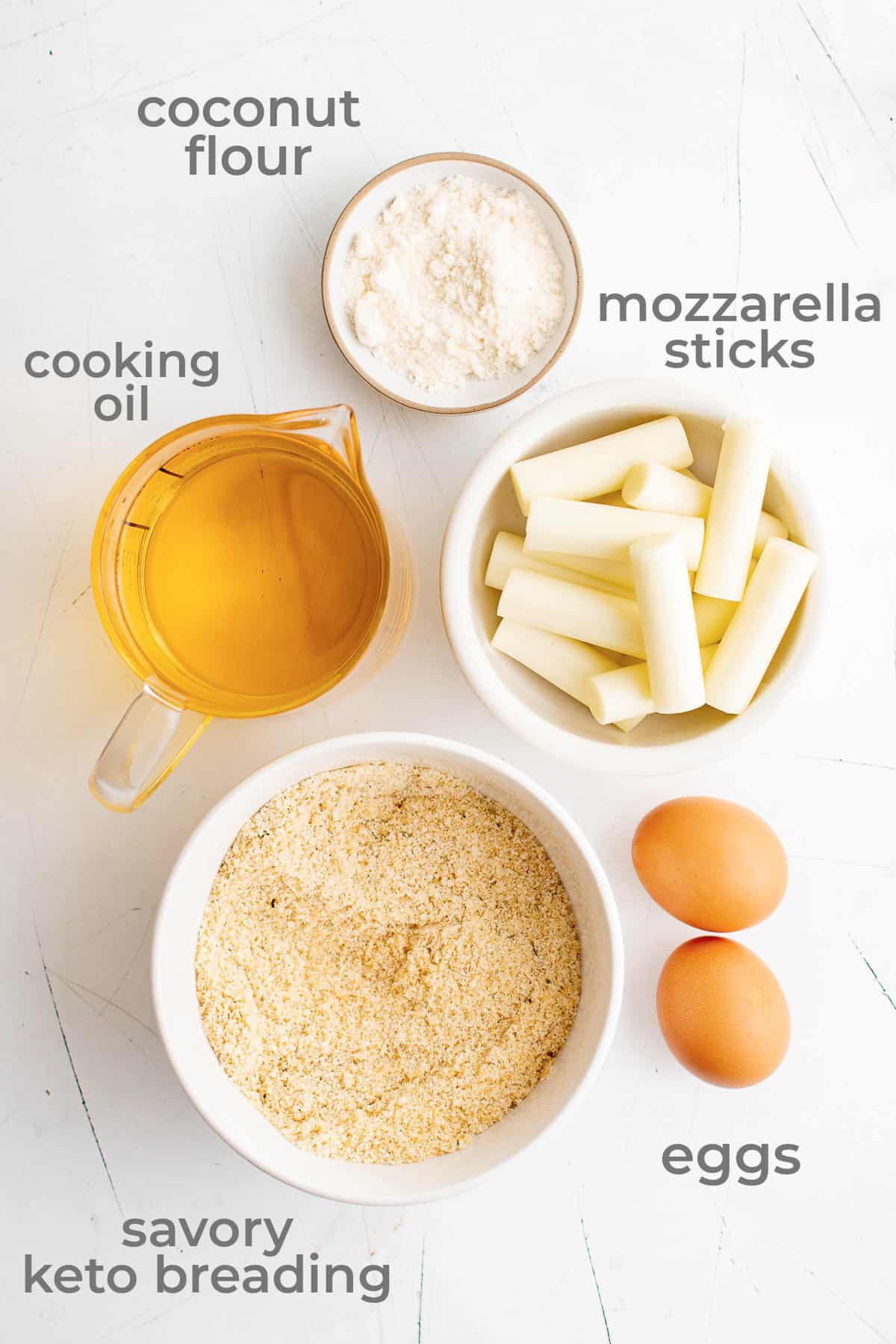 Ingredients for mozzarella cheese sticks - coconut flour, eggs, oil, keto breading