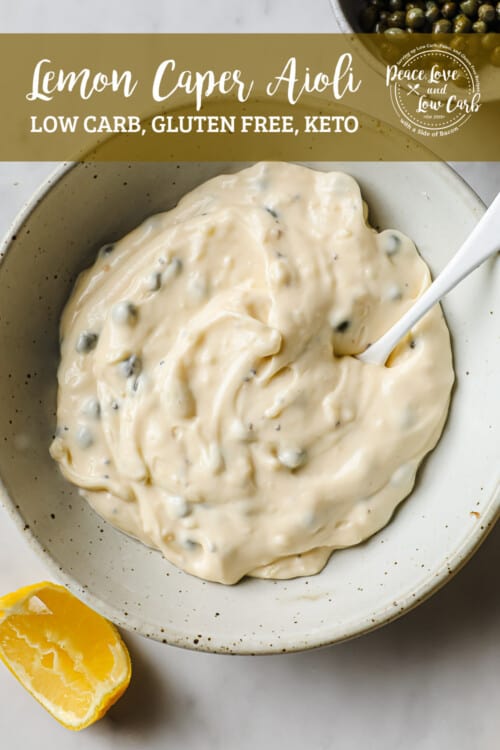 a ceramic bowl, full of lemon caper aioli, garnished with a lemon and capers