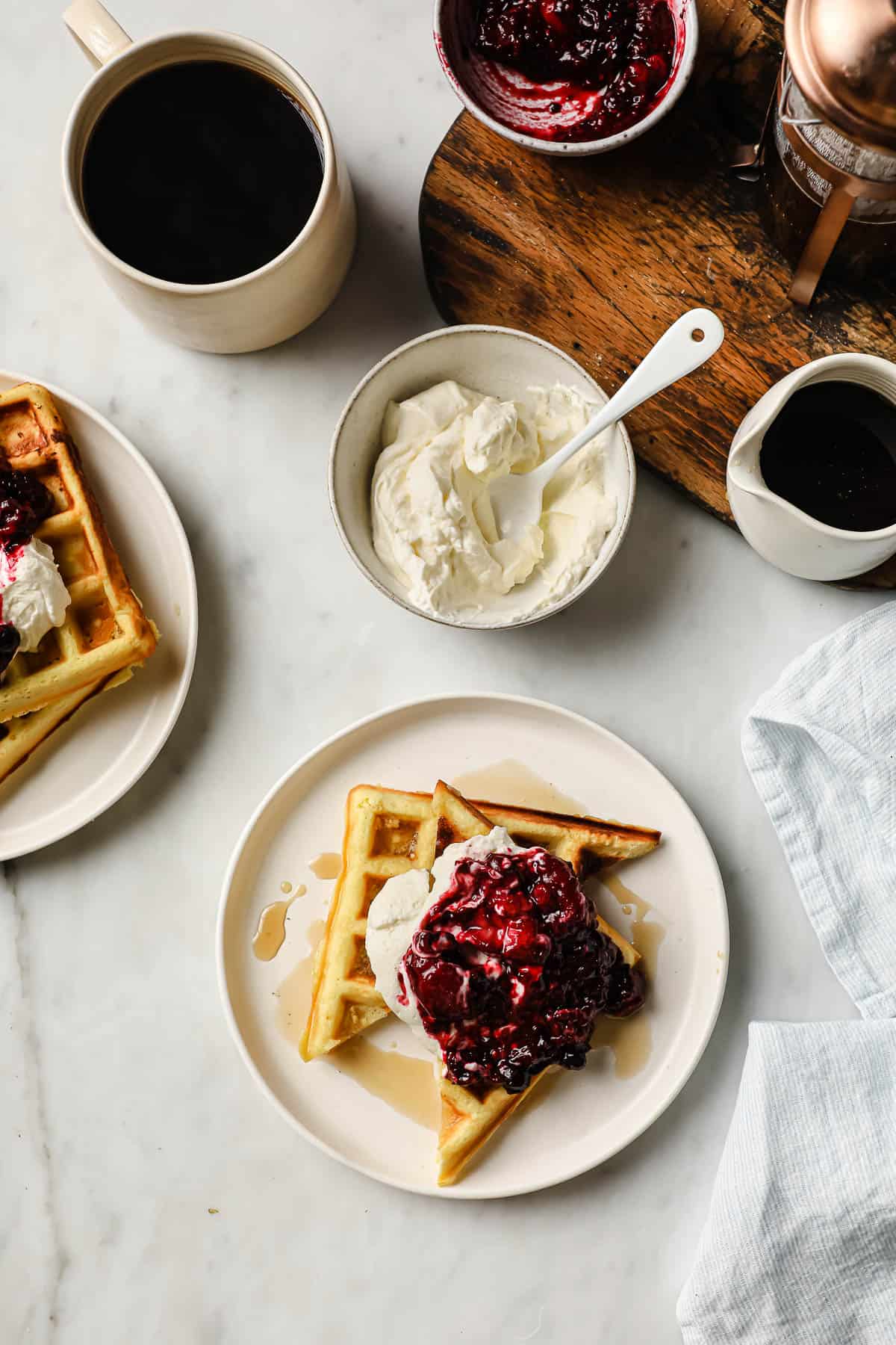 keto waffles topped with syrup, low carb jam, and homemade whipped cream
