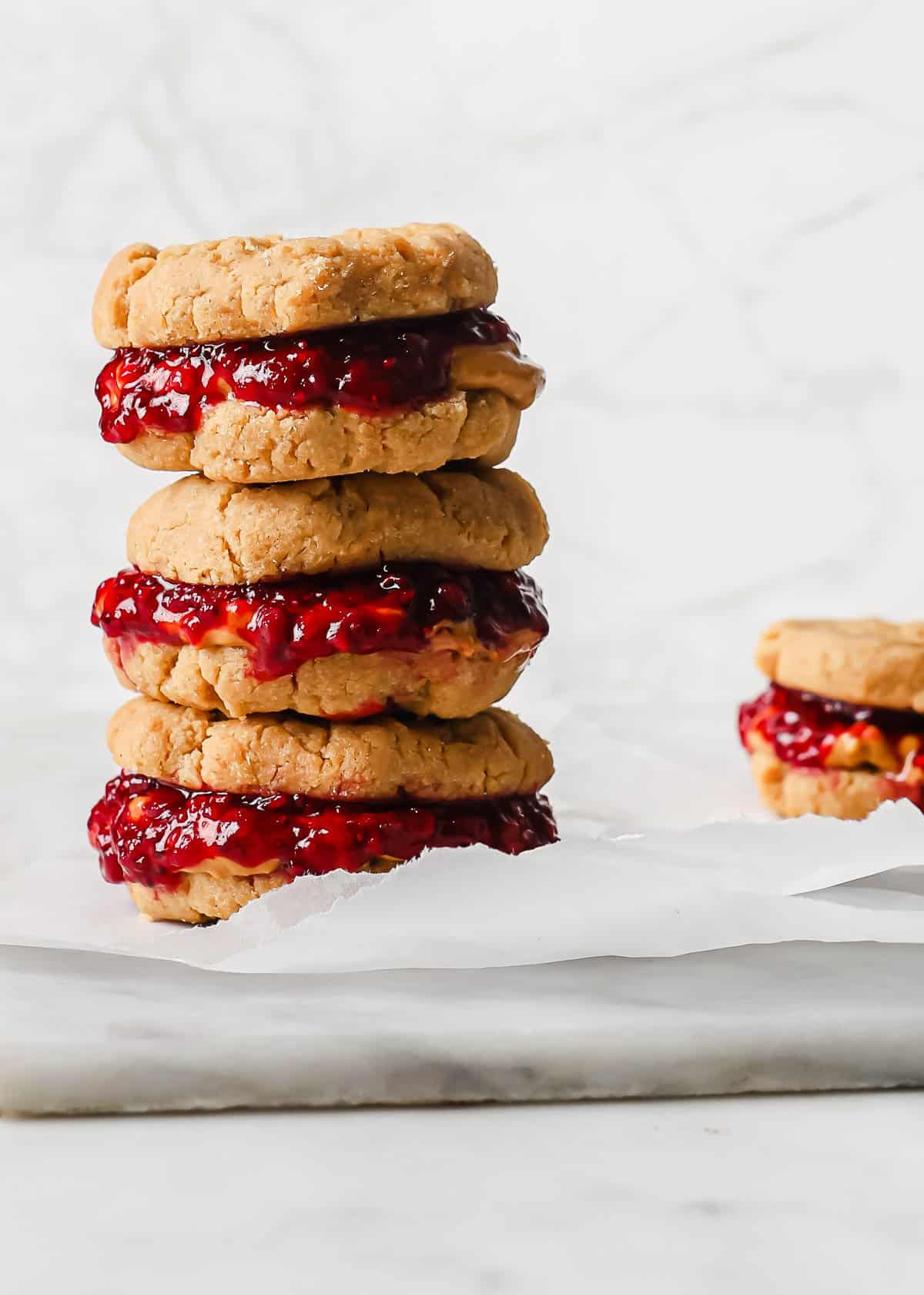 a stack of low carb peanut butter and jelly cookies on parchment paper