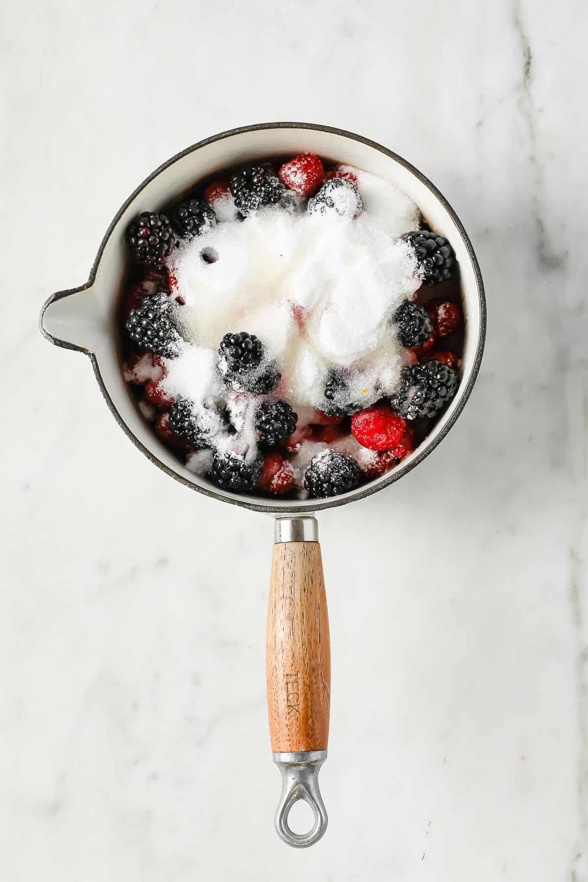 strawberries, raspberries, blackberries, sweetener, and lemon juice in a sauce pan
