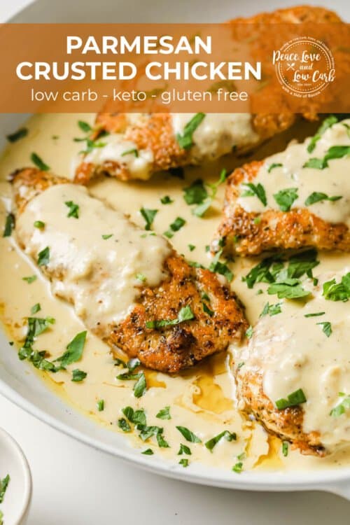 a white pan with crispy chicken breasts and a velvety cream sauce, garnished with parsley