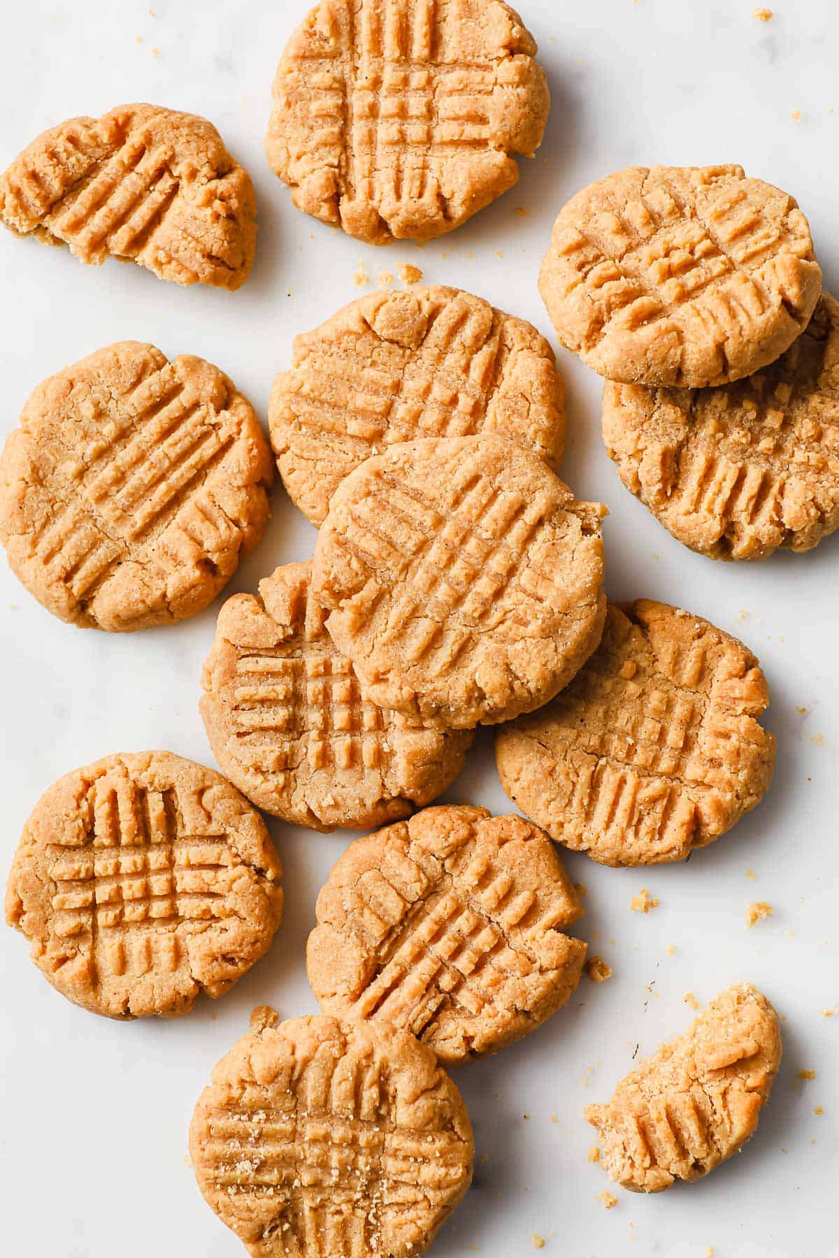 a pile of flourless peanut butter cookies on a marble background